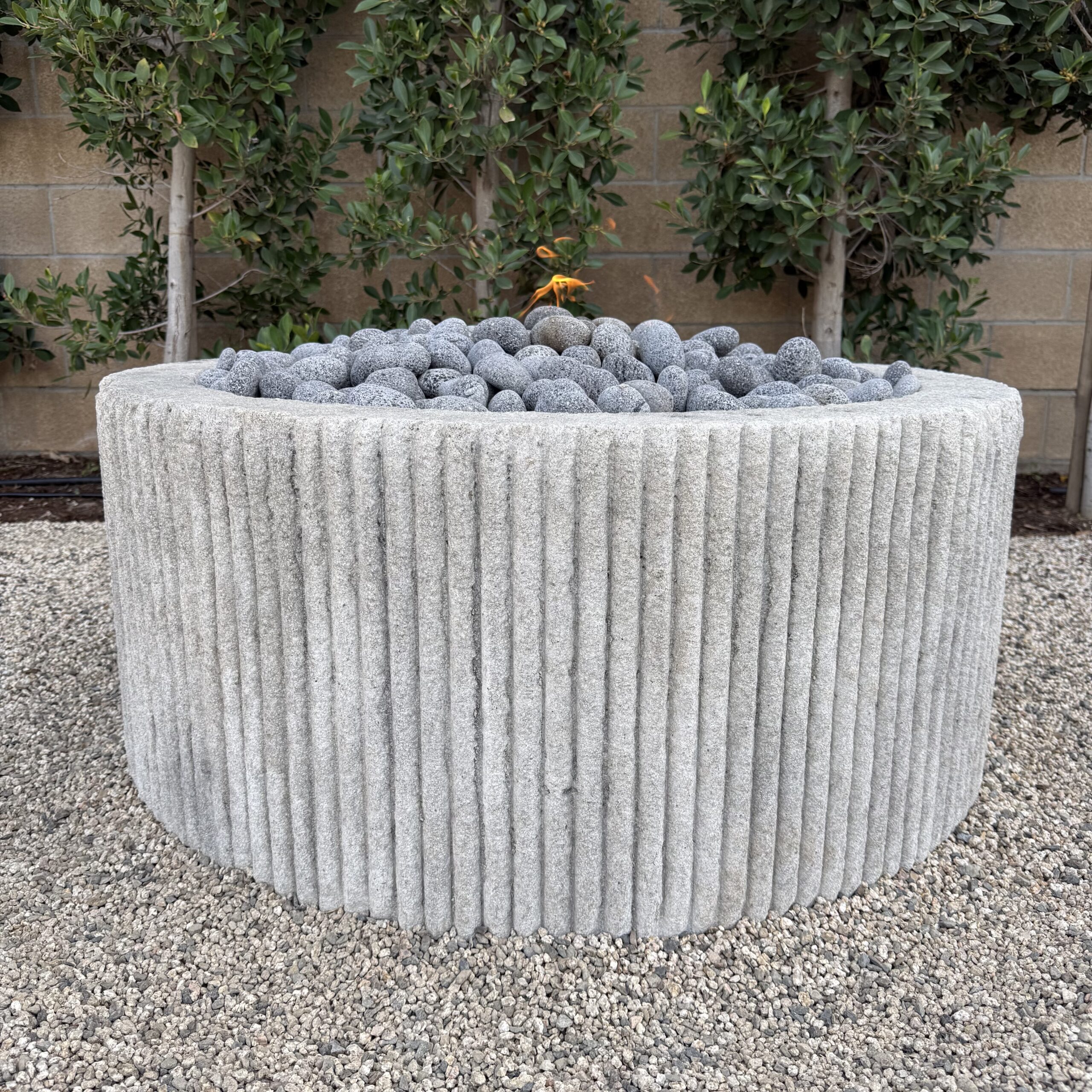Custom Limestone Texture Fire Pit with Fluted Edges with Fire Pebbles