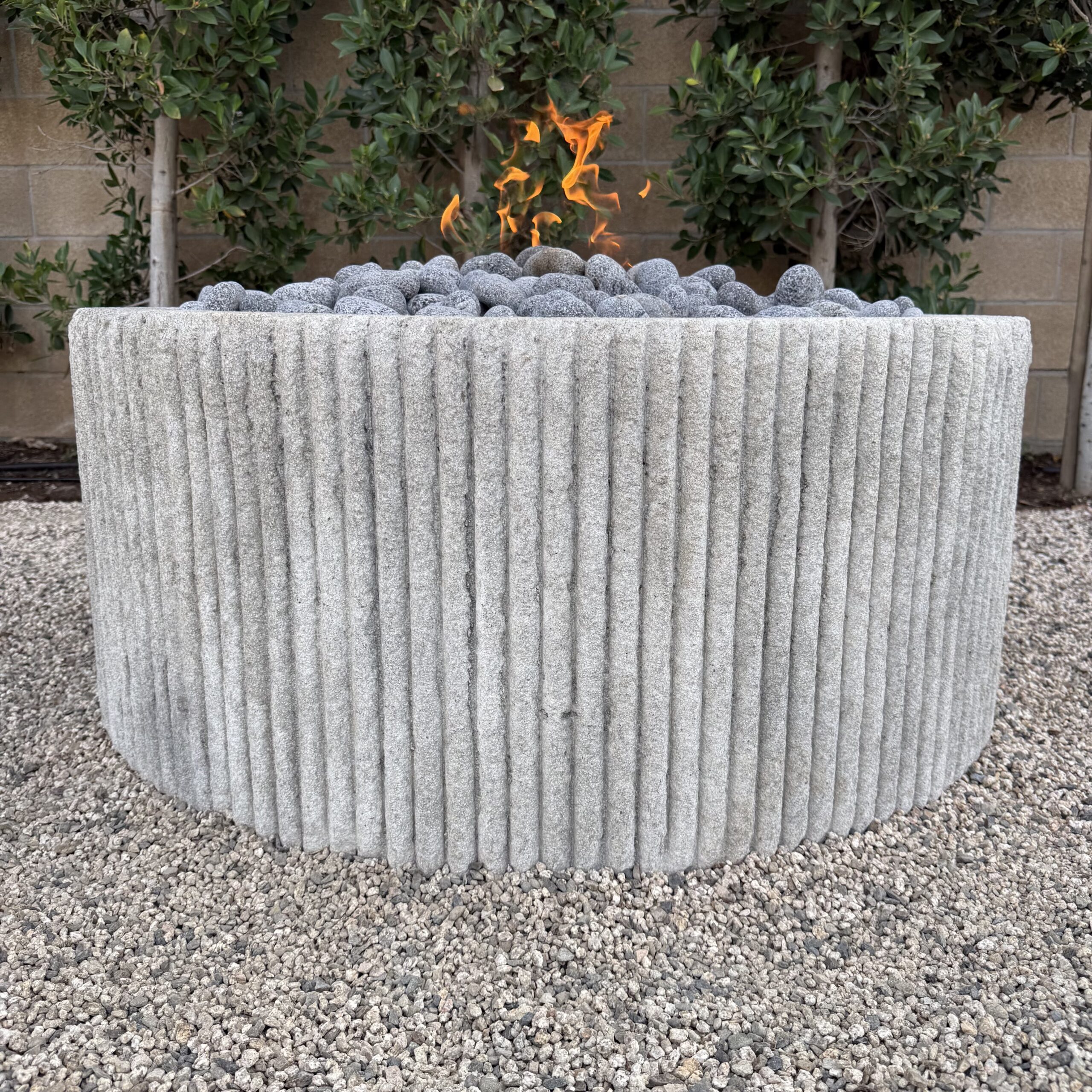 Custom Limestone Texture Fire Pit with Fluted Edges with Fire Pebbles