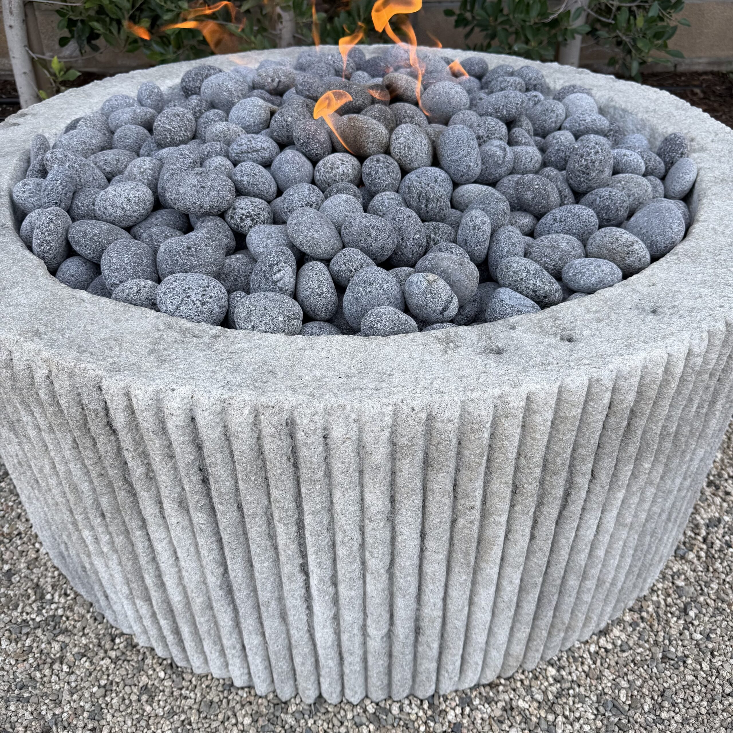 Custom Limestone Texture Fire Pit with Fluted Edges with Fire Pebbles